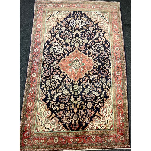 405 - A Central Persian Sarouk rug / carpet, hand-knotted in deep blue, and soft tones of red, green, and ... 