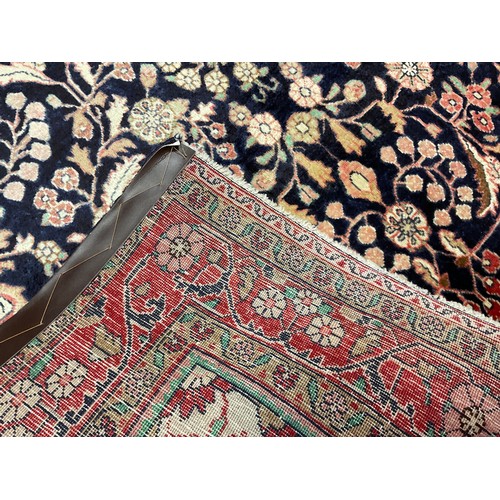 405 - A Central Persian Sarouk rug / carpet, hand-knotted in deep blue, and soft tones of red, green, and ... 