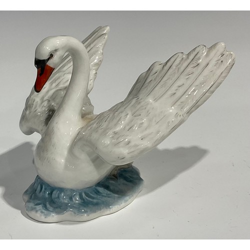 60 - A Berlin porcelain model, of a swan, swimming with wings outstretched, the feathers picked out in mo... 