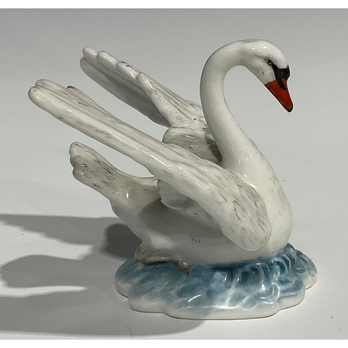 60 - A Berlin porcelain model, of a swan, swimming with wings outstretched, the feathers picked out in mo... 