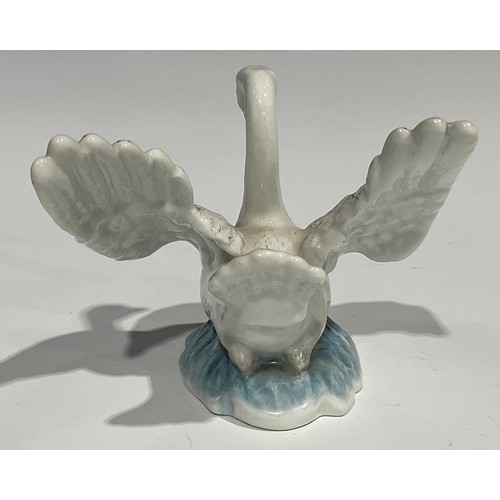 60 - A Berlin porcelain model, of a swan, swimming with wings outstretched, the feathers picked out in mo... 