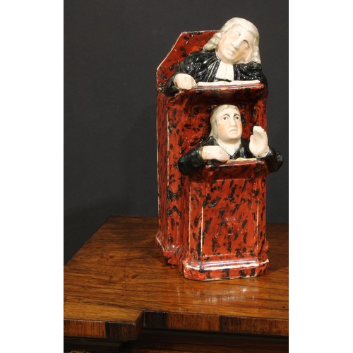 65 - A Staffordshire Vicar and Moses group, typically modelled and coloured in polychrome, 26cm high, c.1... 