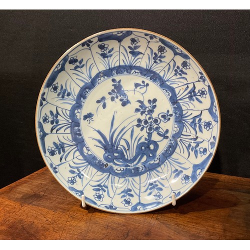 70 - A Chinese circular dish, painted in tones of underglaze blue with flowers and rock work, Kraak type ... 