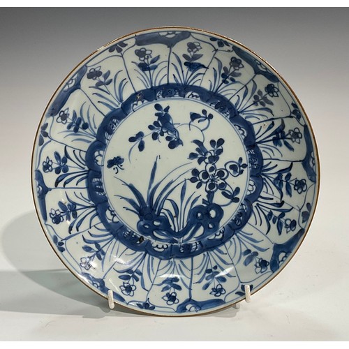 70 - A Chinese circular dish, painted in tones of underglaze blue with flowers and rock work, Kraak type ... 