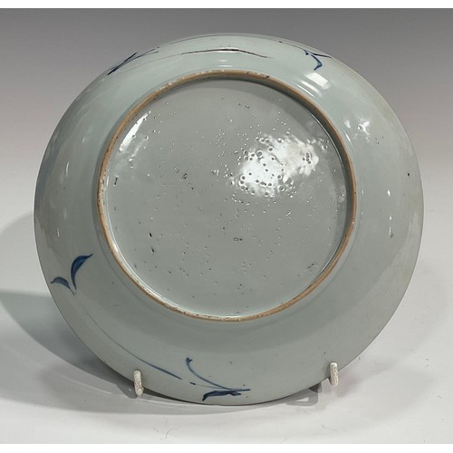 70 - A Chinese circular dish, painted in tones of underglaze blue with flowers and rock work, Kraak type ... 