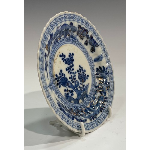 71 - A Chinese fluted shaped circular dish, painted in tones of underglaze blue with flowers and rock wor... 