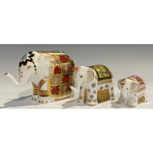 74 - A Royal Crown Derby paperweight, Elephant, printed in the 1128 pattern, trunk raised, gold stopper; ... 