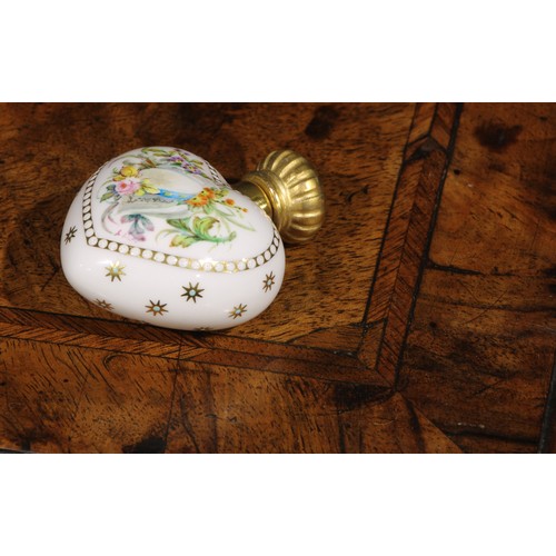 100 - A Lynton porcelain heart shaped scent bottle, painted by Stefan Nowacki, monogrammed, with a musical... 