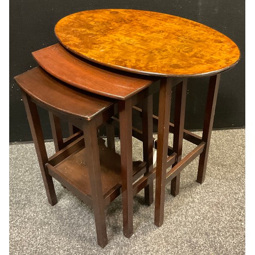 90A - A nest of three walnut and mahogany tables, the largest with oval burr walnut top, 54cm high x 58cm ... 