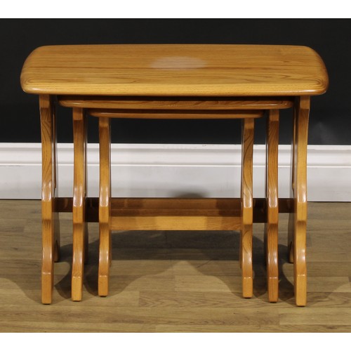 104 - An Ercol Chantry nest of three occasional tables, the largest 42cm high, 57cm wide, 35.5cm deep