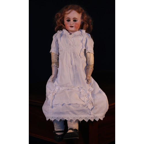 6117 - A bisque shoulder head doll, the bisque head with inset fixed brown glass eyes, painted features inc... 