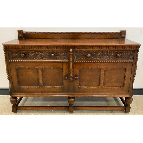 67 - A mid 20th century carved oak sideboard, quarter galleried top, pair of carved drawers to frieze, pa... 