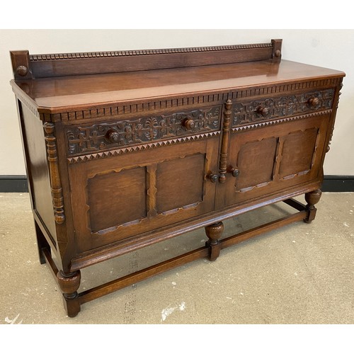 67 - A mid 20th century carved oak sideboard, quarter galleried top, pair of carved drawers to frieze, pa... 