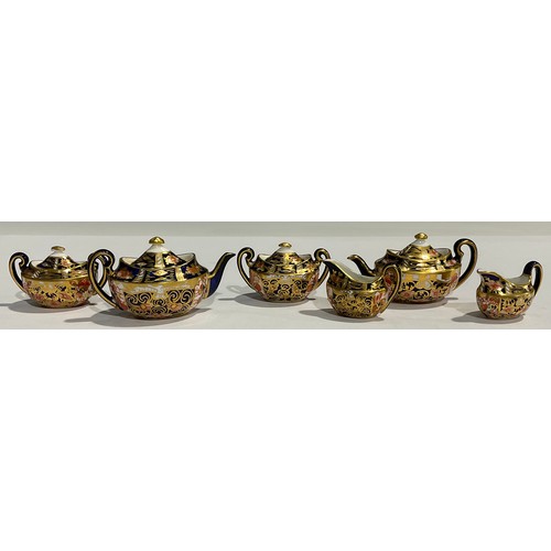 15 - A Royal Crown Derby three piece miniature Imari tea service, 2451 pattern, the teapot 8cm wide, prin... 
