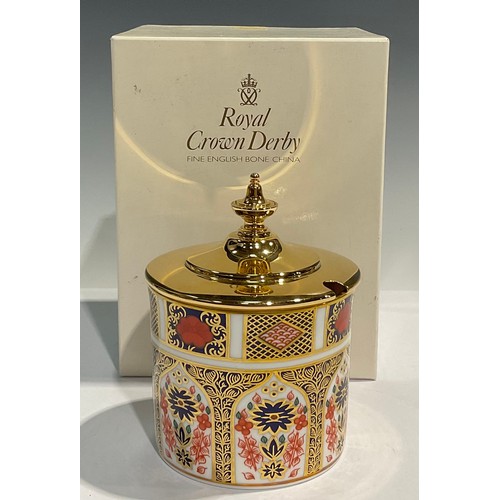 19 - A Royal Crown Derby Imari 1128 pattern cylindrical preserve pot, gilt metal cover with finial, 10.5c... 