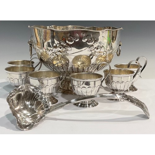 28 - A silver plated pedestal punch bowl, embossed with floral swags, lion mask handles, with ladle and s... 