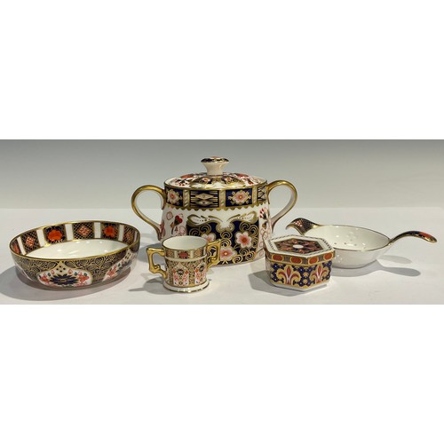 62 - A Royal Crown Derby Imari 1128 pattern tea strainer on stand, first quality; an 1128 pattern miniatu... 