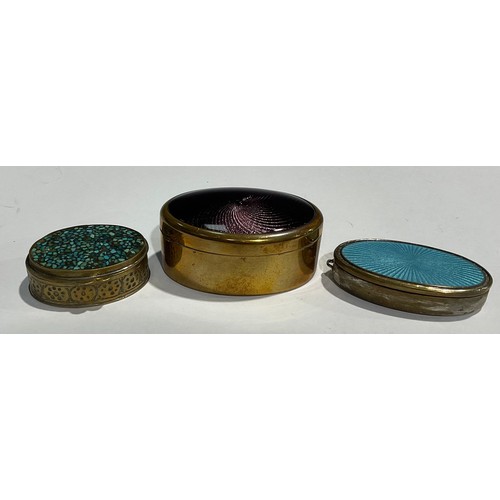 150 - An oval guilloche enamel pill box; another similar; a turquoise inlaid pill box (3)