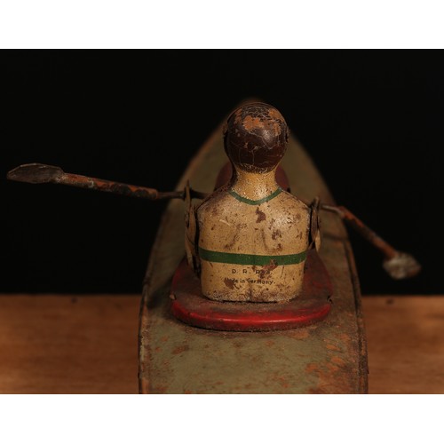 6161 - An early 20th century German tinplate and clockwork rowing boat, fitted with a lone oarsman figure w... 