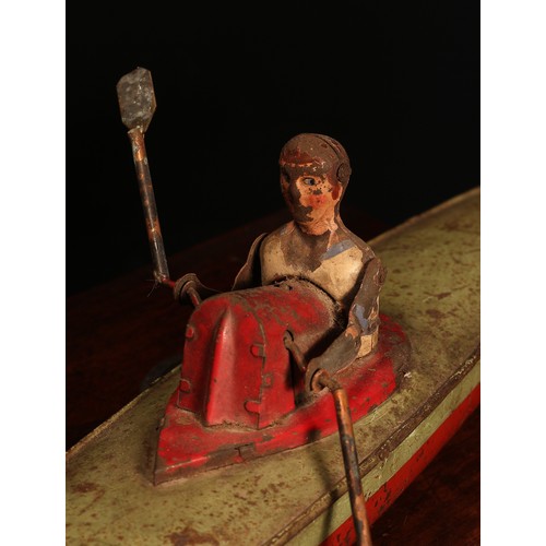 6162 - An early 20th century German tinplate and clockwork rowing boat, fitted with a lone oarsman figure w... 