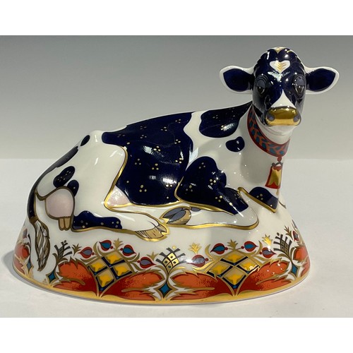 176 - A Royal Crown Derby paperweight, Friesian Cow 'Buttercup', 21st anniversary gold stopper, printed ma... 