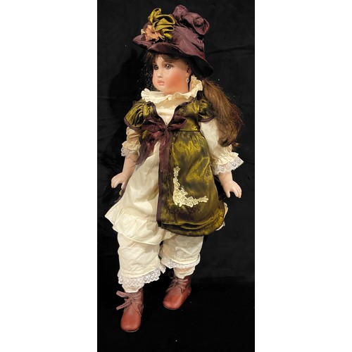 254 - Toys & Juvenalia - a reproduction bisque head and painted composition bodied doll, the bisque head i... 