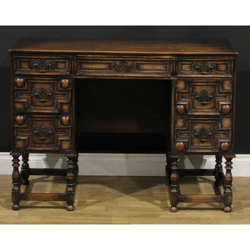 109 - A Charles II inspired oak desk, rectangular top above an arrangement of drawers, 77.5cm high, 106.5c... 