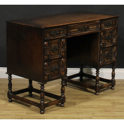 109 - A Charles II inspired oak desk, rectangular top above an arrangement of drawers, 77.5cm high, 106.5c... 