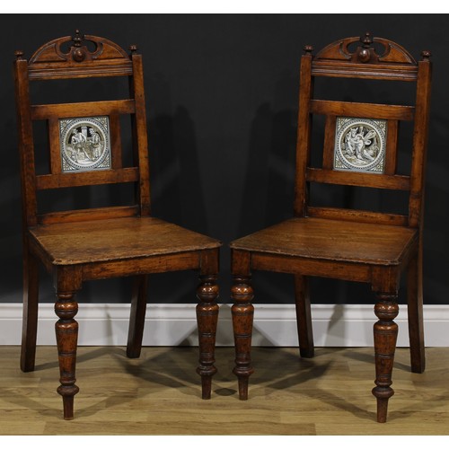 115 - A pair of late Victorian tile back oak hall chairs, of Shakespearean interest, the Shakespeare serie... 