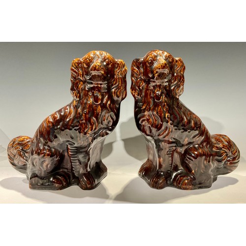 41 - A pair of Victorian Staffordshire treacle glazed mantel dogs, 28.5cm high