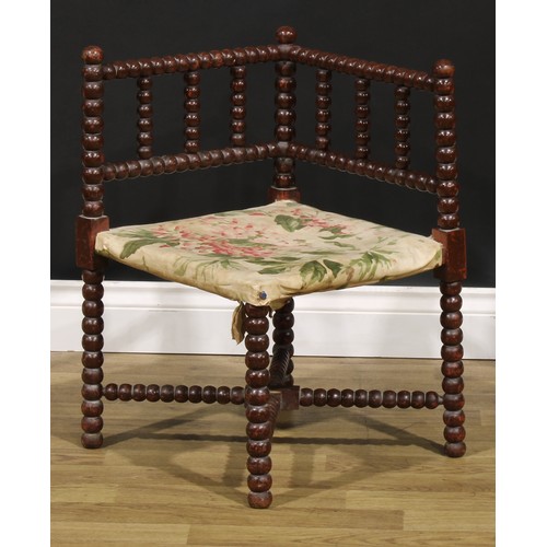 1173 - An Arts & Crafts bobbin-turned corner chair, of small proportions, 61cm high, 41cm square