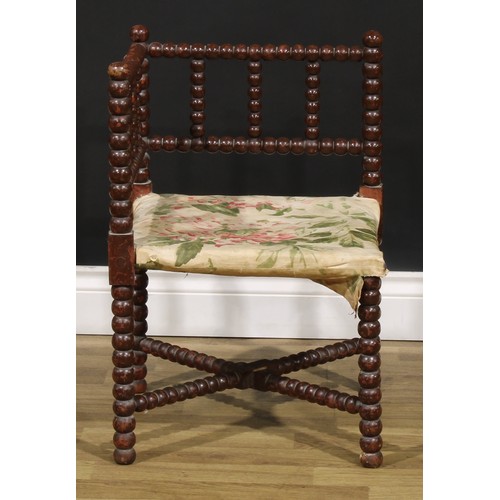 1173 - An Arts & Crafts bobbin-turned corner chair, of small proportions, 61cm high, 41cm square