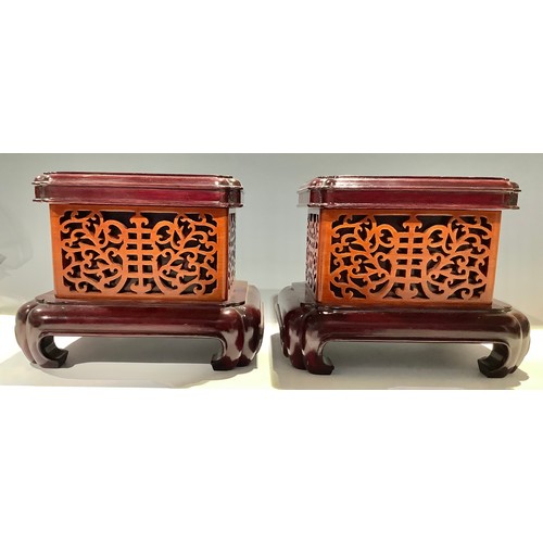 57 - A pair of Chinese rounded rectangular stands, 20.5cm high