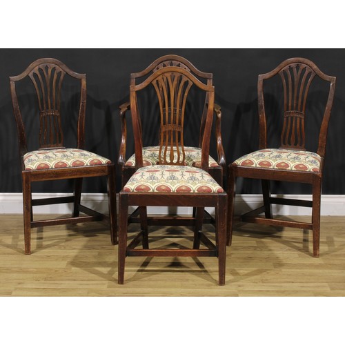1265 - A set of four George III mahogany dining chairs, comprising three side chairs and a carver, the side... 