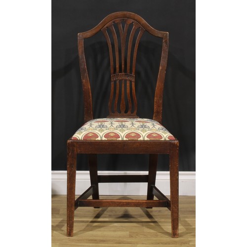 1265 - A set of four George III mahogany dining chairs, comprising three side chairs and a carver, the side... 