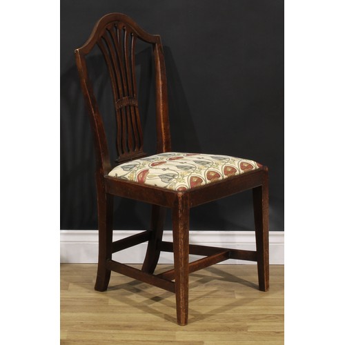 1265 - A set of four George III mahogany dining chairs, comprising three side chairs and a carver, the side... 
