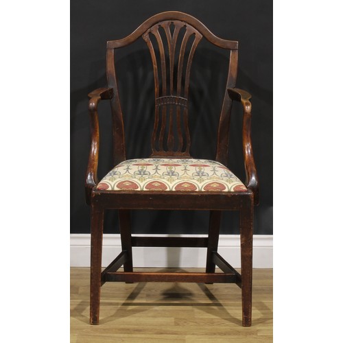 1265 - A set of four George III mahogany dining chairs, comprising three side chairs and a carver, the side... 