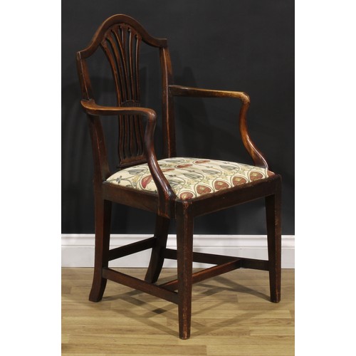 1265 - A set of four George III mahogany dining chairs, comprising three side chairs and a carver, the side... 