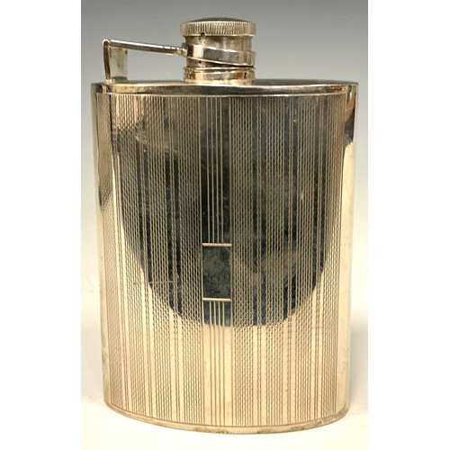 57 - An Art Deco style silver curved rounded rectangular hip flask, engine turned in bands, hinged bayone... 