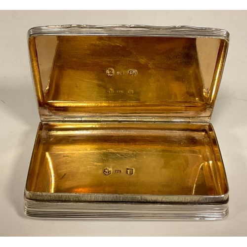 12 - A George III silver rounded rectangular snuff box, engine turned overall, hinged cover, gilt interio... 