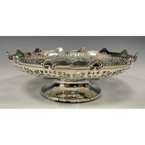 44 - A silver shaped circular pedestal sweet meat bowl, the undulating sides with stylised flowerheads an... 