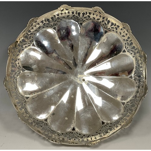 44 - A silver shaped circular pedestal sweet meat bowl, the undulating sides with stylised flowerheads an... 