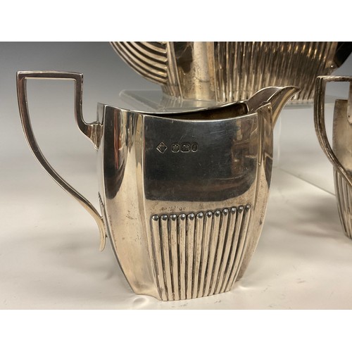 53 - A Victorian silver three piece tea set,  ebony handled teapot, sugar bowl and milk jug, Martin, Hall... 