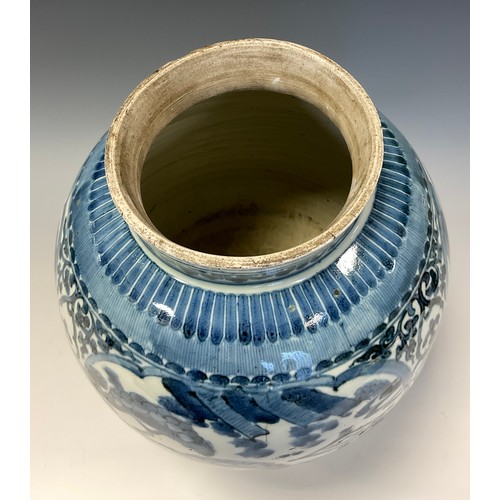 151 - A 17th century Japanese ovoid vase, painted in tones of underglaze blue in the Chinese taste with fi... 