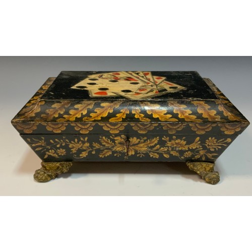 163A - A Regency penwork sarcophagus games box, the hinged cover decorated with playing cards, brass leafy ... 