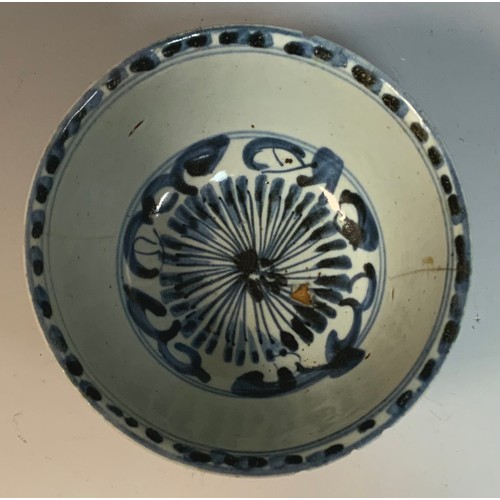 166A - A Chinese bowl, naively decorated in underglaze blue with stylised flowers and scrolls, 14cm diam