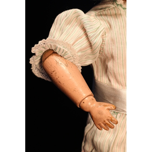 4010 - An early 20th century Schoenhut carved and painted wooden character doll, the carved and painted woo... 
