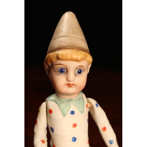 4031 - A novelty all-bisque jointed miniature doll, dressed as a performing Clown, the bisque head inset wi... 