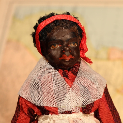 4048 - An early 20th century black composition jointed doll, painted features, black flock type hair, 18.5c... 