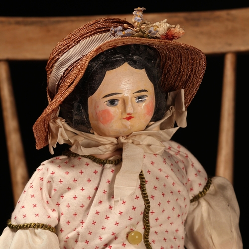 4059 - A 19th century carved wooden shoulder head and partially stuffed cloth bodied doll, probably German ... 